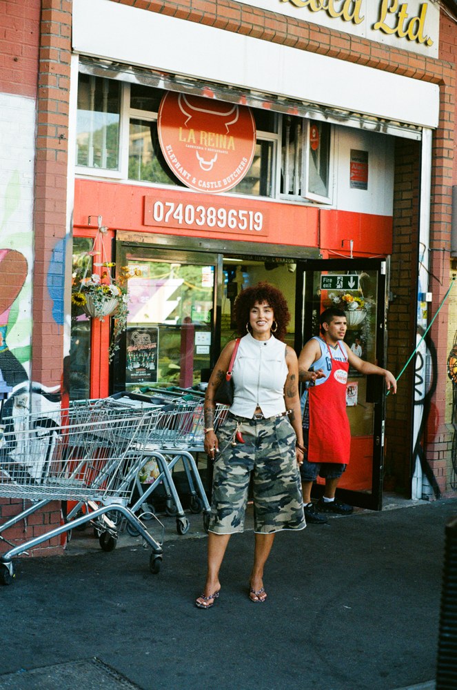Woman outside a red storefront
