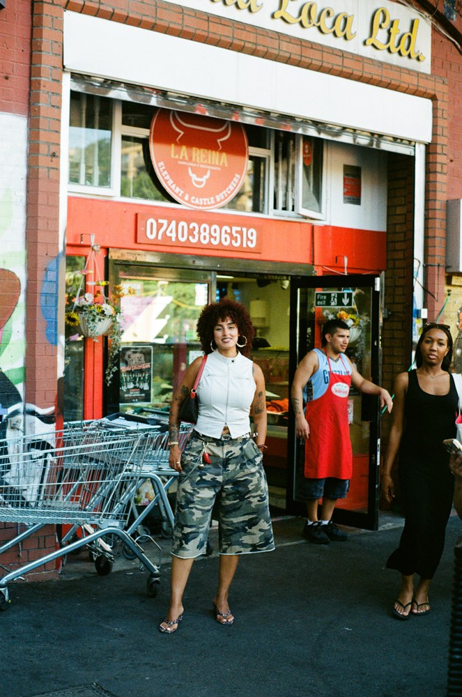 Street portrait outside a busy storefront