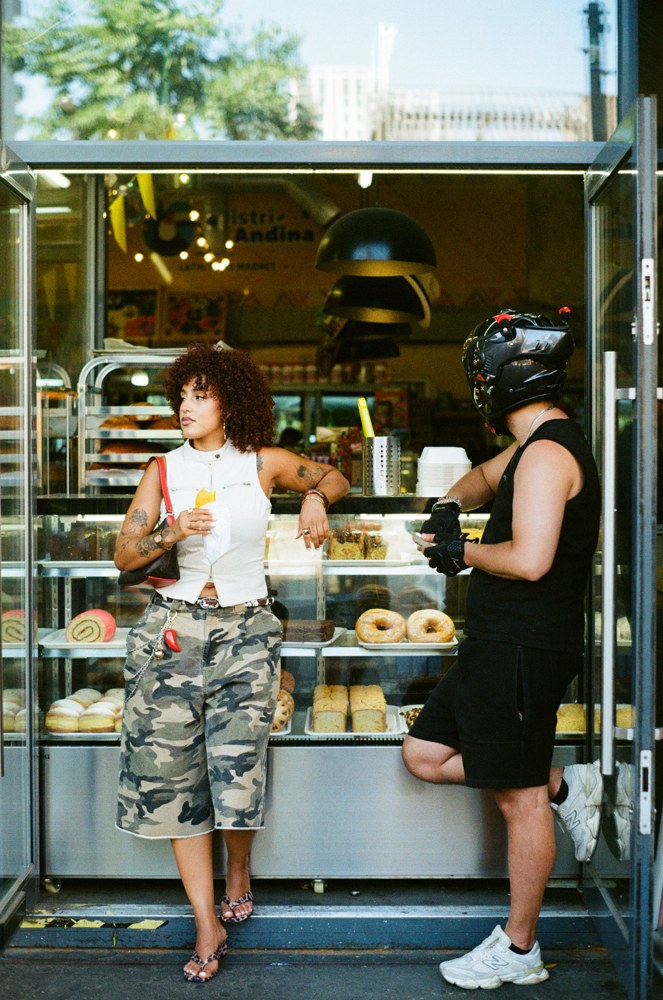 Woman and helmeted rider at a bakery counter