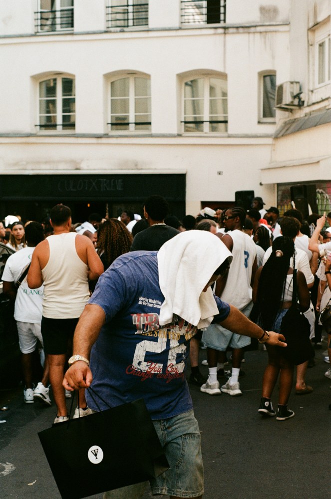 Dancer in a blue shirt at a street gathering