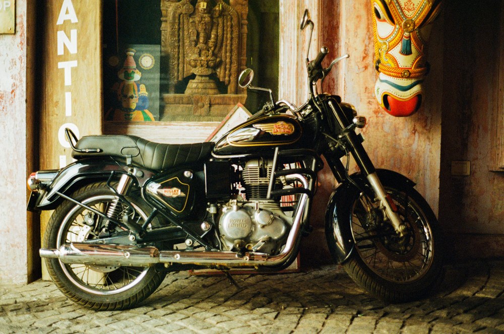 Black motorcycle outside a decorated shop