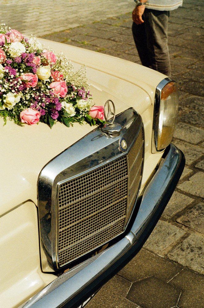 Flowers on the bonnet of a cream car