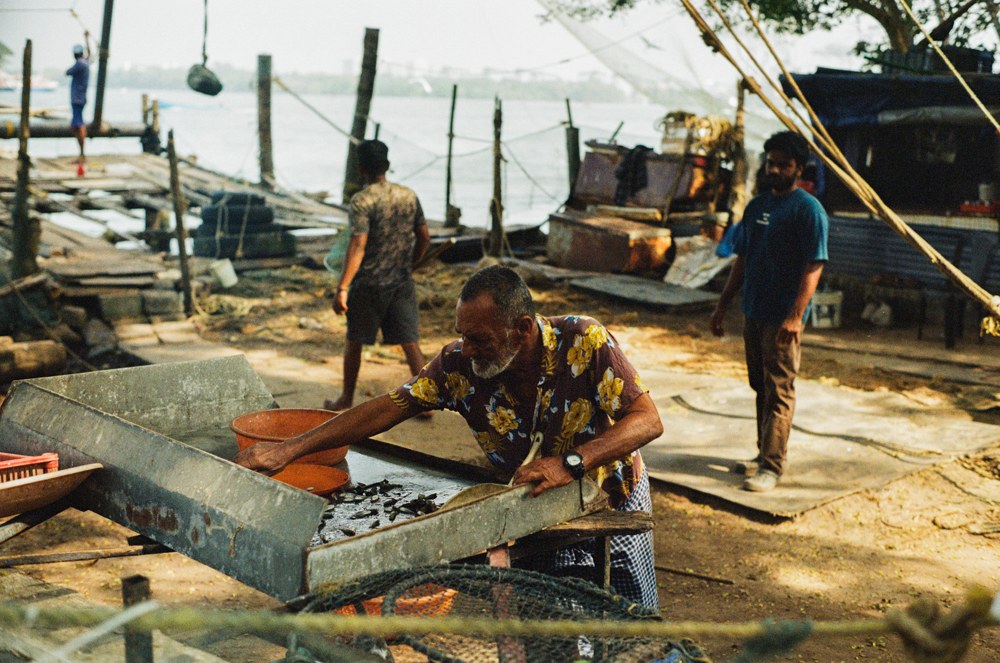 Man working beside fishing nets at the waterfront