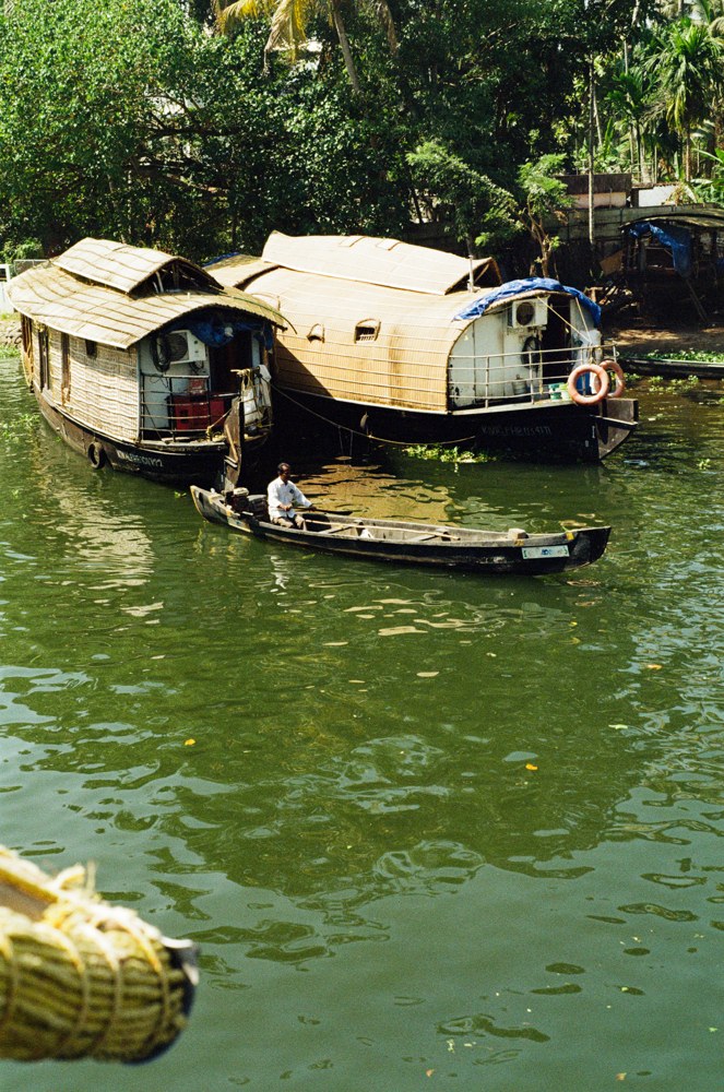 Canoe passing two houseboats