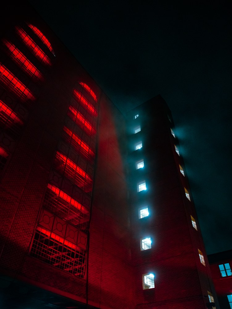 Building illuminated in red and blue at night