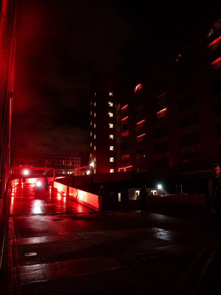 Red-lit walkway and buildings at the event