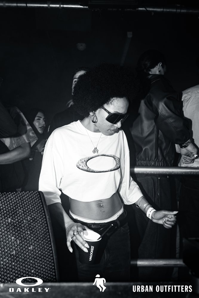 Guest in an Oakley shirt and sunglasses at the Oakley and Urban Outfitters event