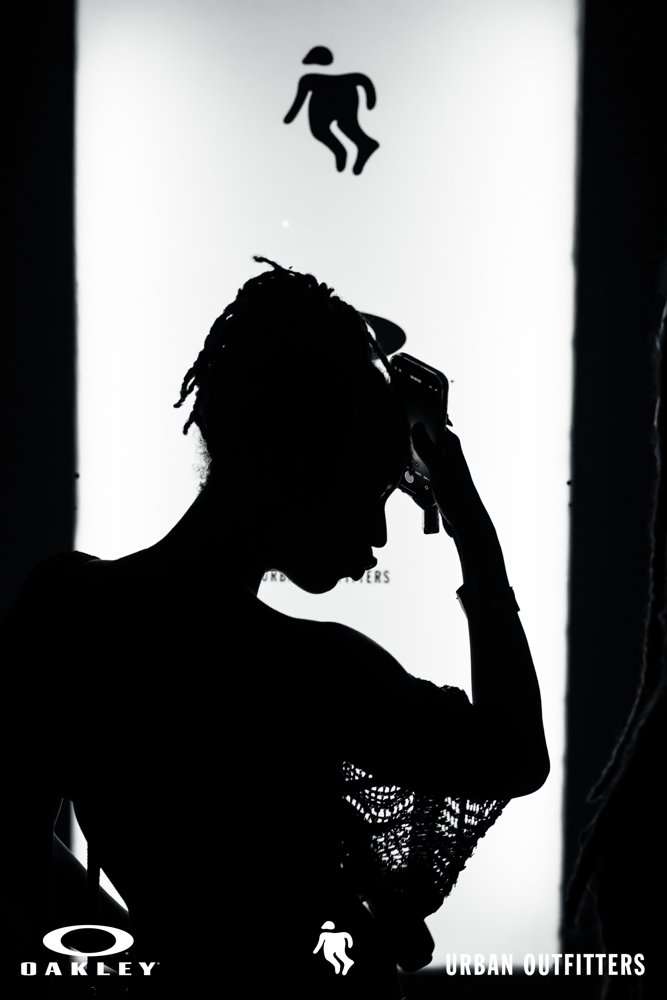 Guest silhouetted against event signage at the Oakley and Urban Outfitters event