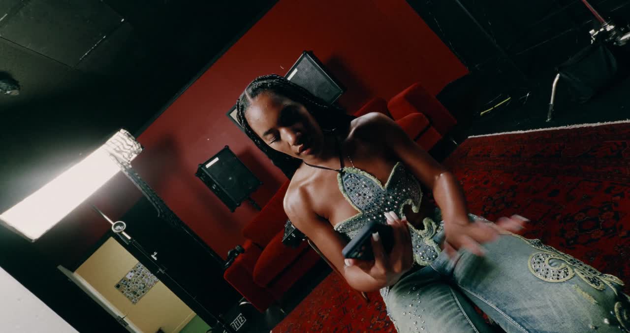 A performer at the decks in a red-lit studio, from the A.S.B showreel